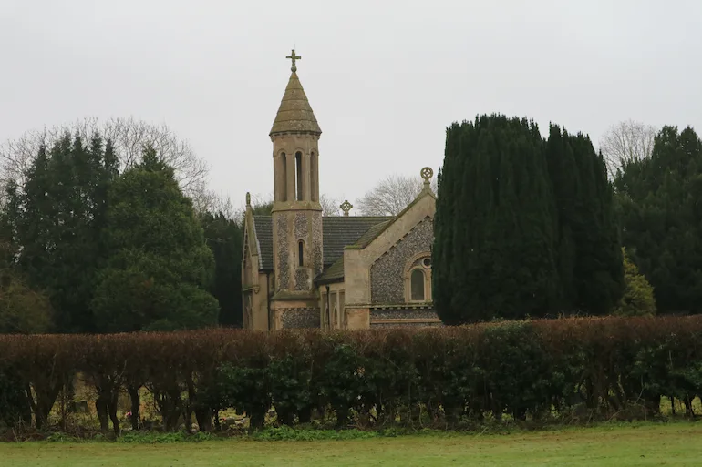 Church at West Hyde YPC Photograph of a church beyond a large hedge.